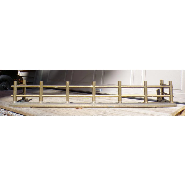 Antique Large Fireplace Fender Fire Surround constructed from tubular Brass rods mounted on an iron weighted angular brass...