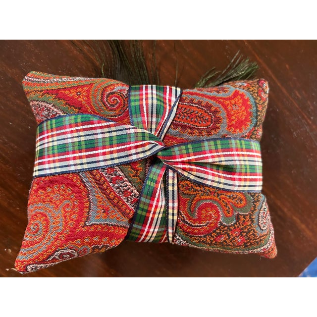 A Balsam sachet pillow handmade from an antique paisley shawl, embellished with peacock feathers. A heavenly scent!