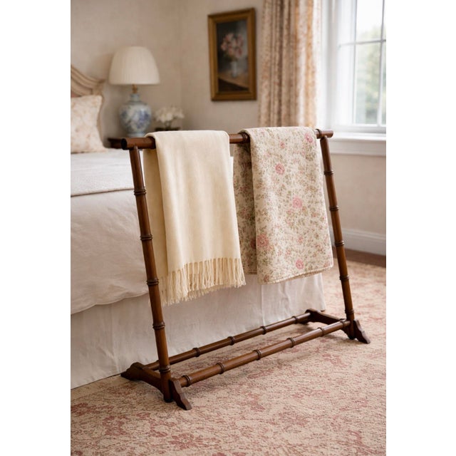 A classic vintage faux bamboo valet stand featuring a warm wood finish and a clean, architectural silhouette. The upper...