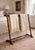 A classic vintage faux bamboo valet stand featuring a warm wood finish and a clean, architectural silhouette. The upper...