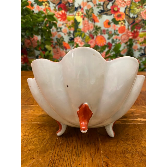 Beautiful hand painted bowl with colorful design with asian ladies. The bowl has 3 porcelain feet and scalloped edge. It...