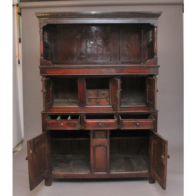 Early 18th Century oak tridarn / court cupboard of exceptional quality, the open top section having a moulded edge top...
