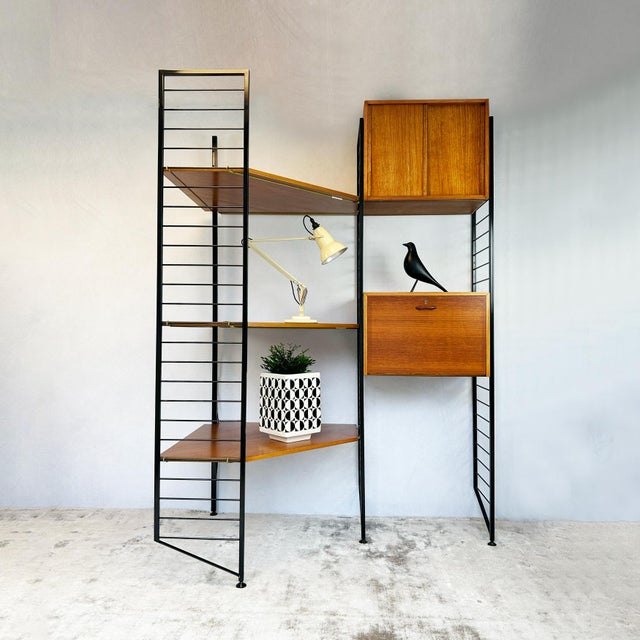 Ladderax modular corner shelving system designed by Robert Heal for Staples in 1964, featuring black steel ladder frames...