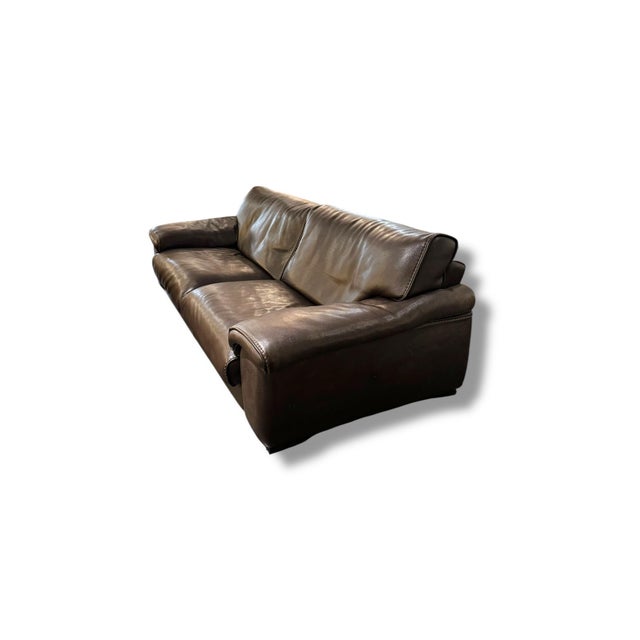 Elegant Roche Bobois leather sofa in a rich chocolate brown tone with soft, oversized cushions and clean contemporary...