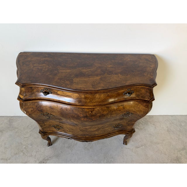 Elegant vintage Italian bombe chest featuring a beautifully shaped serpentine silhouette with dramatic Louis XV inspired...