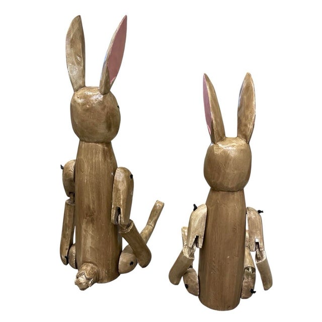 Add a touch of rustic charm to your home with this delightful set of two vintage, handmade wooden rabbit figurines....