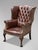 This high-quality, untouched 19th-century brown leather button-back wing armchair is designed in the George III style. The...