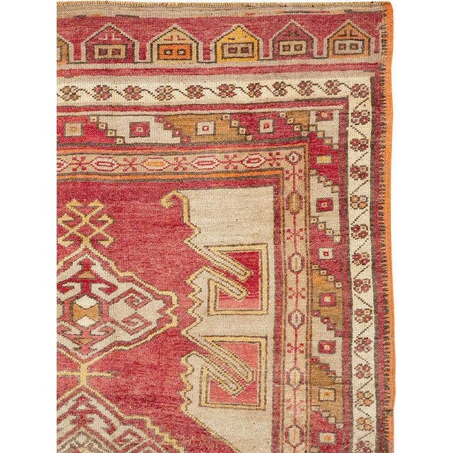 This mid-20th-century Turkish Anatolian gallery carpet presents a bold, vertically organized composition across a warm...