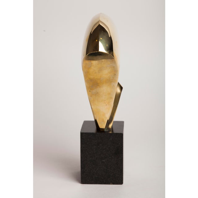 A contemporary non-figurative bronze, its form abstracted into a single sweeping, fan-like volume that rises and unfurls...