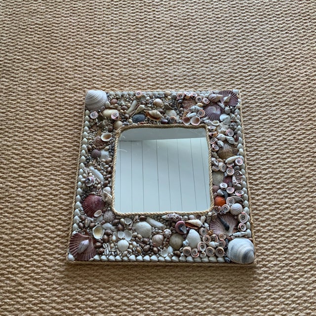 Vintage handmade seashell on wooden board mirror, 20.5” x 22.5” in size. Fantastic mirror that will add a beachy vibe to...