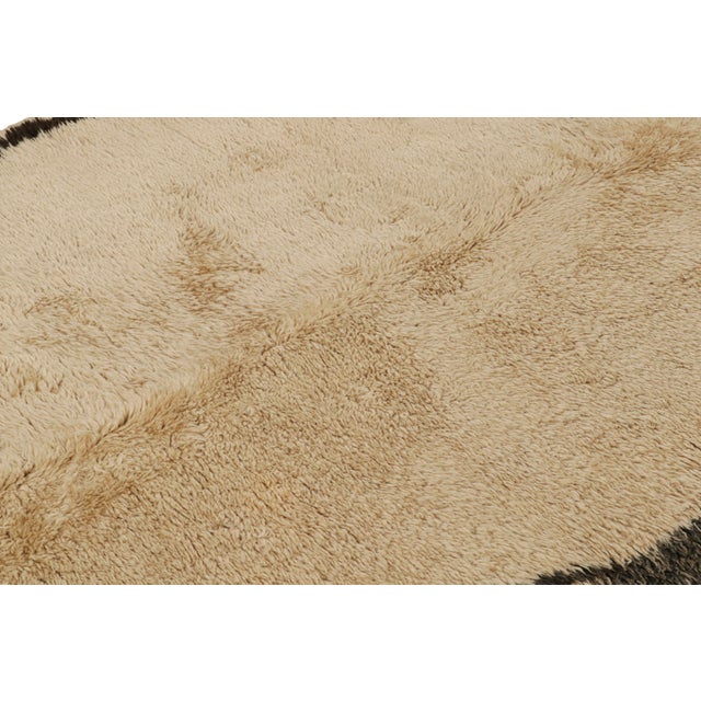 Hand knotted in Morocco originating between 1950-1960, this vintage mid-century Moroccan rug enjoys a spaciousness unique...