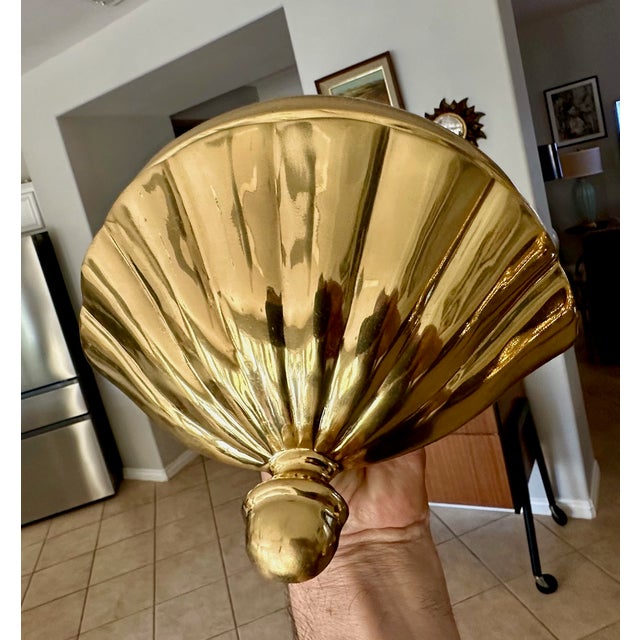 Set of 4 (four) Hollywood Regency cast brass scallop shell shaped uplight wall sconces. Construction is made of solid...