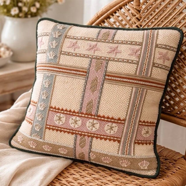 This vintage needlepoint pillow features a charming coastal composition with repeating seashells arranged in a geometric...