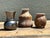 This curated collection of three miniature studio pottery vases offers a delightful study in late 20th-century ceramic...