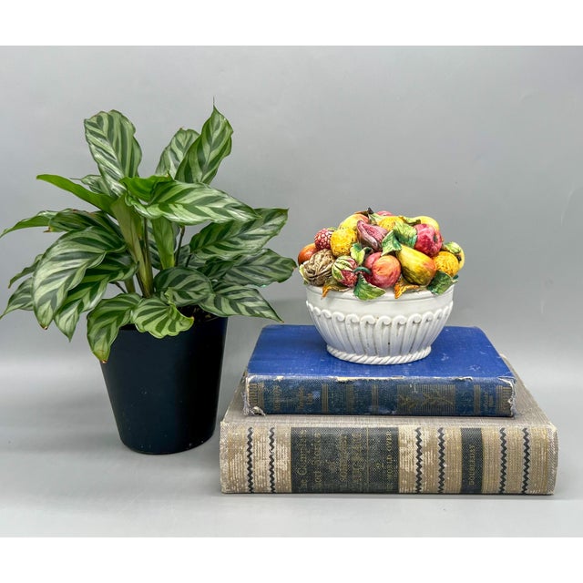 Charming, bright bowl of fruits made in Italy in the mid-late 20th century. Gorgeous, multicolored fruit accented by...