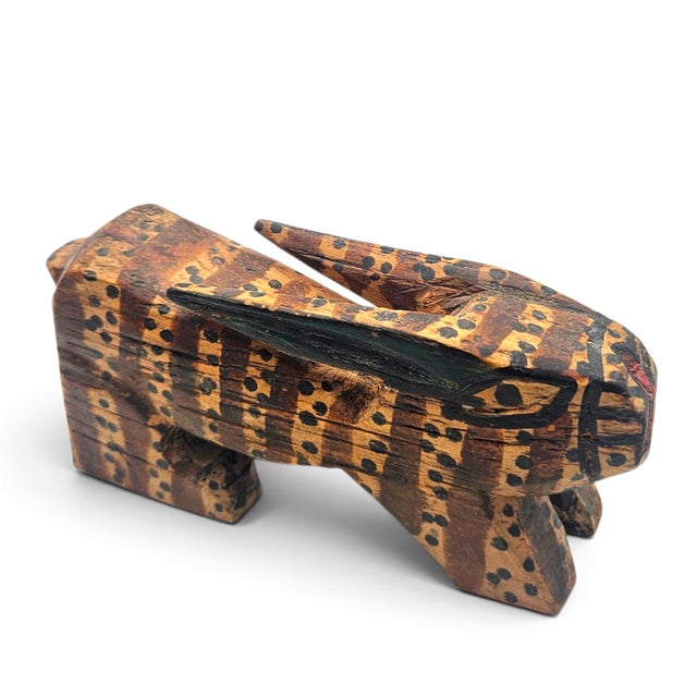 A charming vintage mid-century hand-carved and hand-painted wooden rabbit sculpture. Handcrafted from a single block of...