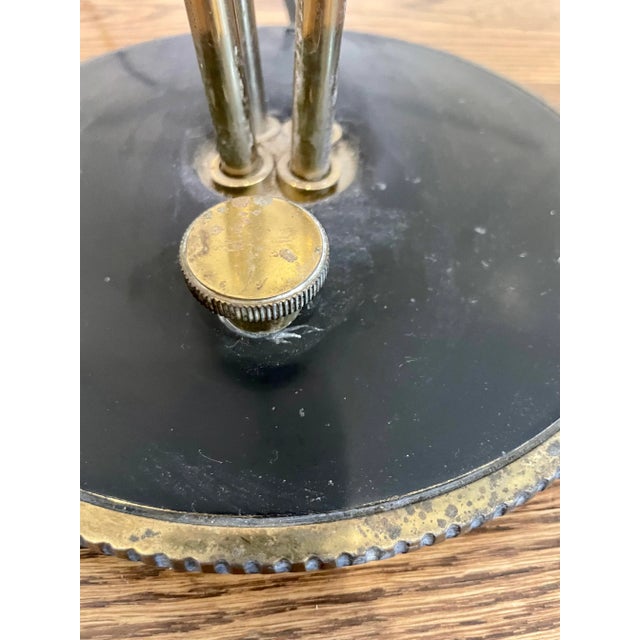 Sculptural retro table lamp. Black cone base with brass rods topped with minimalist clean lined white shade. Add an impact...