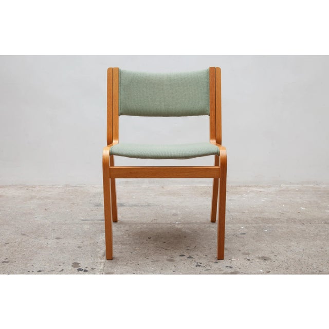 A high quality of curved laminated wooden stacking chairs with woven wool upholstery in olive green. Set of 24 stacking...