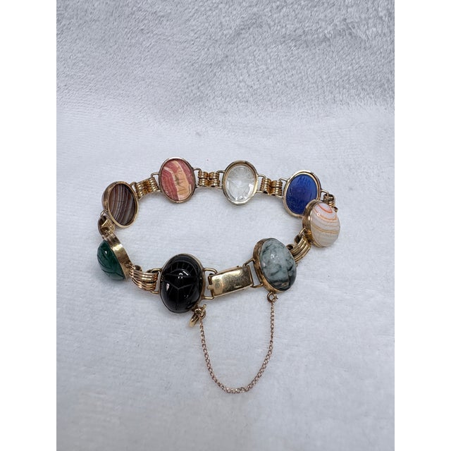 A beautifully preserved mid‑century carved gemstone scarab bracelet for collectors of Egyptian Revival and natural...