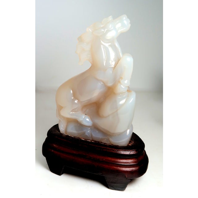 This agate is a truly lovely translucent to opaque. The horse is well-carved. The wood base is carved to fit. Country of...