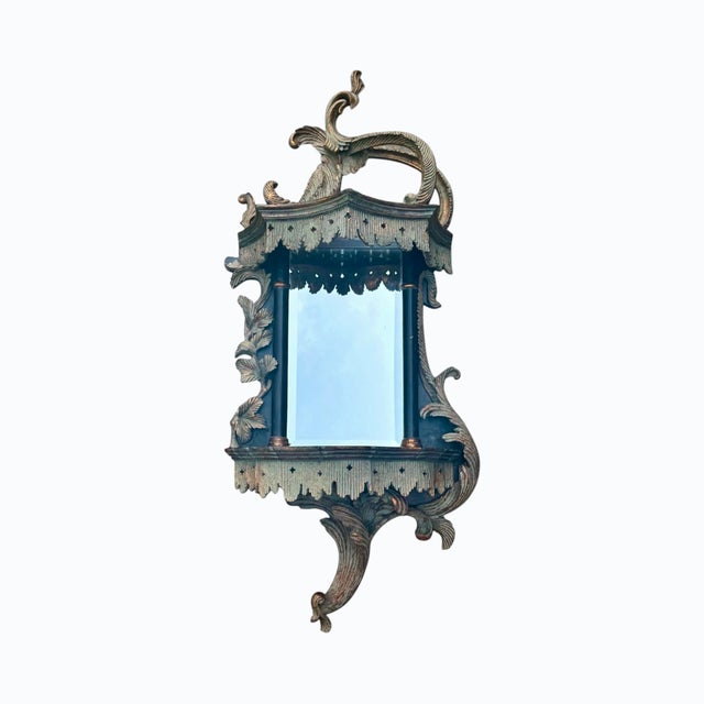 A pair of Chippendale style mirrored wall shelves, circa 2004. These pagoda shaped wooden shelves feature a giltwood...