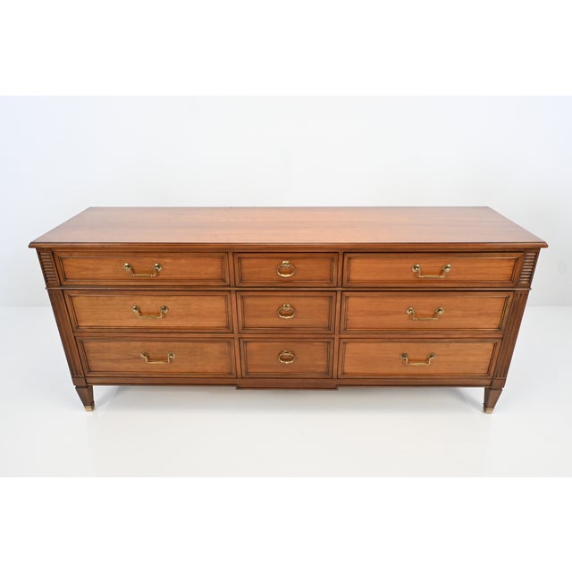 Elegant Kindel Grand Rapids nine-drawer dresser crafted in rich cherry, featuring refined neoclassical styling with fluted...
