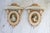 Pair of petite ornate wood wall shelves with cameo portraits. No makers mark. Some age wear to wood. Pictured.