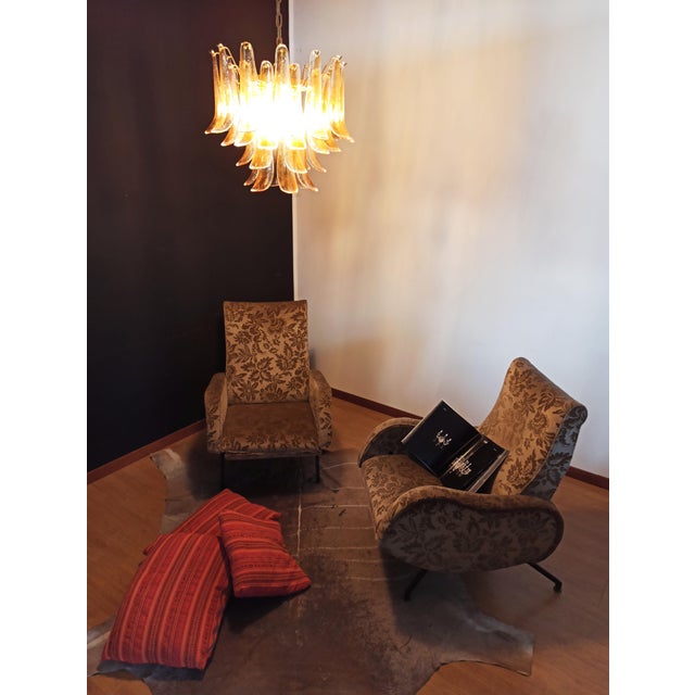 Fantastic chandelier with 36 transparent with an amber spot inside glasses, gold painted structure. The glasses are very...