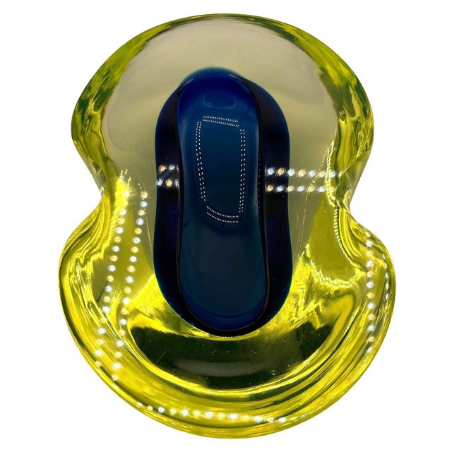 Circa 1960 Mid-century Murano art glass bowl/ashtray with a biomorphic shape and fluid uranium glass form with a suspended...