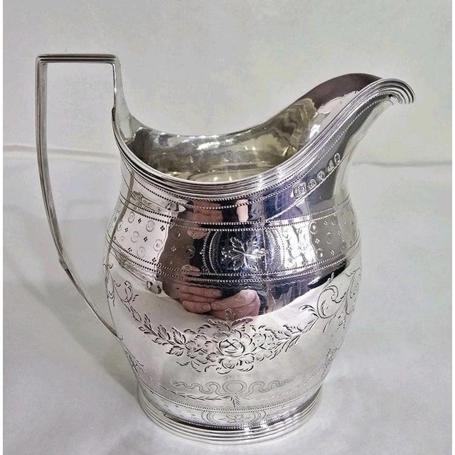 A George III sterling silver cream or milk jug by Samuel Godbehere, Edward Wigan and James Boult, hallmarked London 1801....