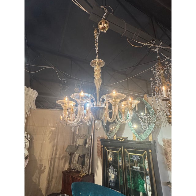 The Murano Gold Glass 8 Arm Chandelier is a luxurious and elegant lighting fixture. Perfect for adding a touch of...