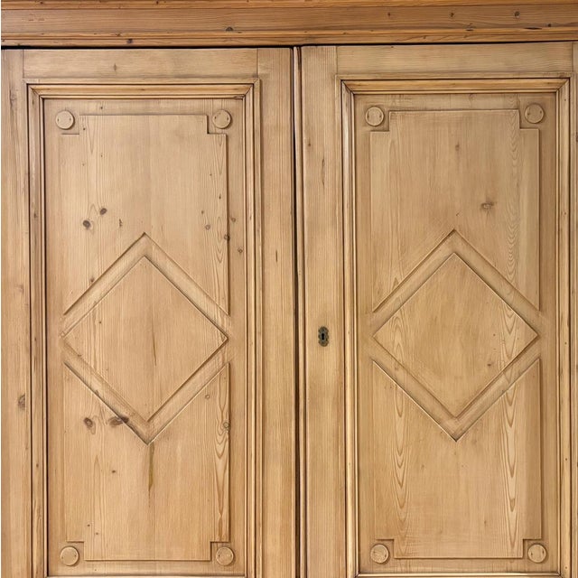 A stately set of Georgian-style pine cabinets crafted circa 1920, originally removed from a large home in Holland. These...