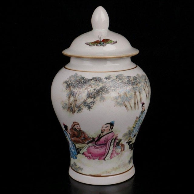 Graceful Chinese general jar (Jiangjun Guan) with domed pointed‑finial lid. Finished in famille‑rose style polychrome...