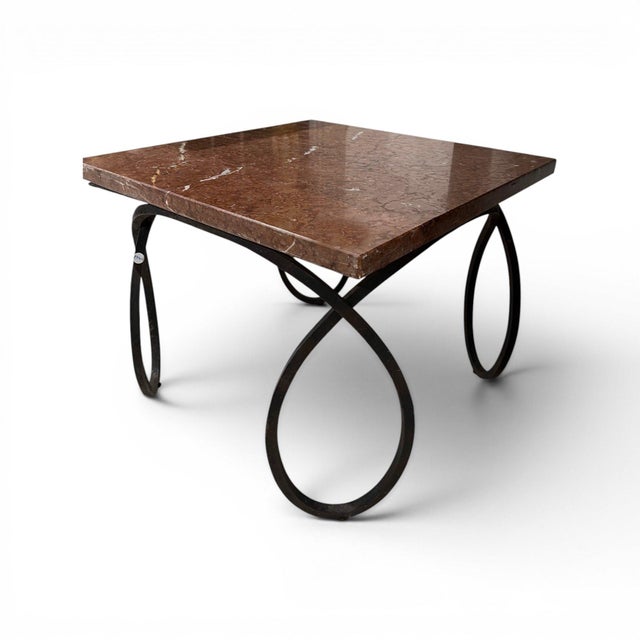 This distinctive early 20th-century French coffee table features a beautifully veined marble top supported by a sculptural...
