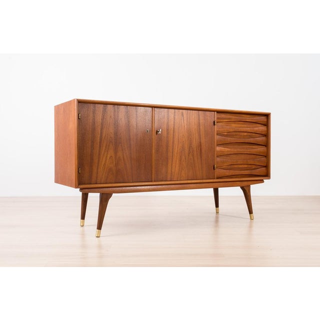 Introducing the sideboard designed by Sven Andersen – an exquisite masterpiece that seamlessly blends the timeless...