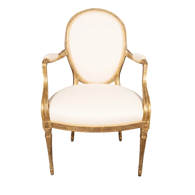 Pair Of George III Giltwood Armchairs with oval upholstered backs and bowed upholstered seats raised on circular tapered...