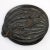 A wooden lid with intricate and artistic carvings on both sides. It has a flange that would have fit a base. The top of...