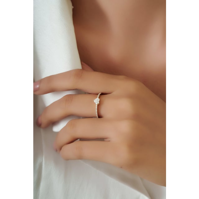 Crafted in 14K yellow gold, this delicate solitaire ring features a sparkling 0.53 carat heart-cut diamond measuring...