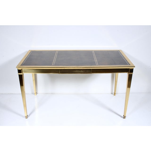 Circa 1970 Italian All Brass and Inlaid Leather Writing Desk. Featuring a heavy, rectangular, all Brass desk with single...