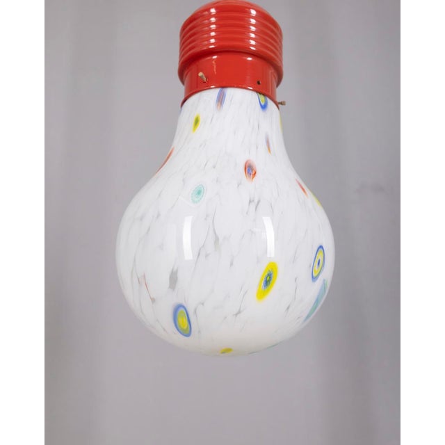 Pendant lamp with red metal frame and large decorated glass light bulb-shaped lampshade, Italian design, 1980s. Up to 250V...