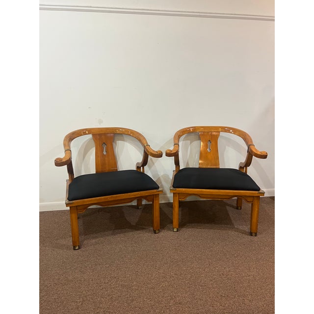 Opulent pair of large Chinese ming style horseshoe club chairs originally designed by James Mont. These chairs epitomize...