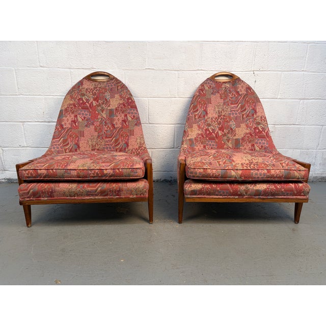 Striking pair of walnut lounge chairs upholstered in bold red fabric and styled after the glamorous gondola design of...
