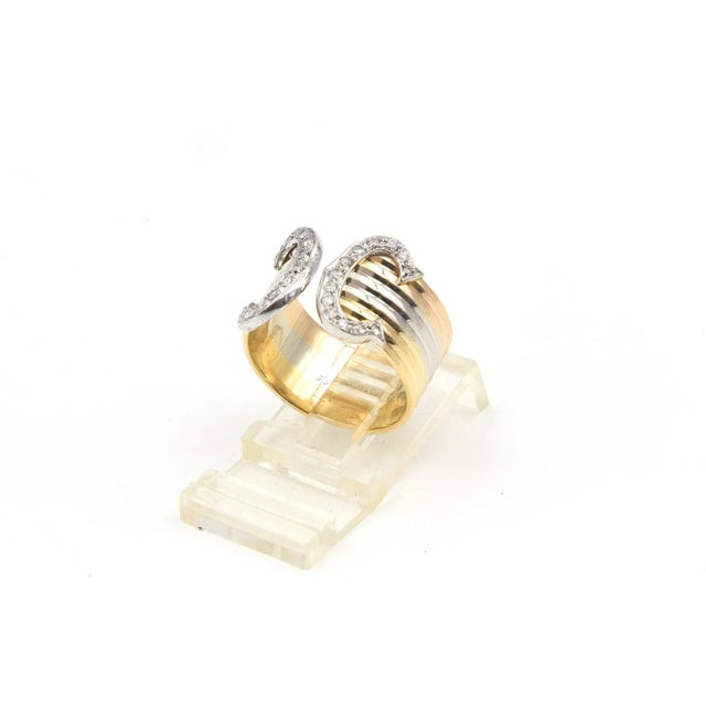 Cartier Trinity 18k ring featuring white, rose and yellow gold double bands terminating with the Cartier double diamond C....
