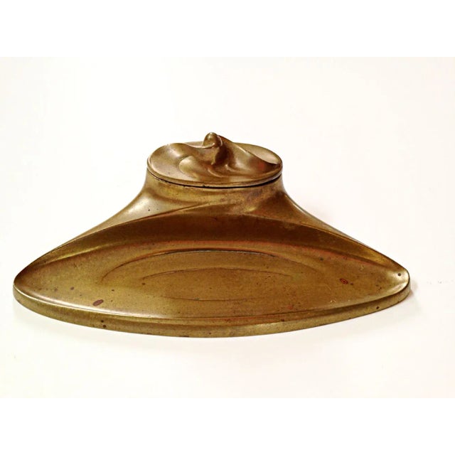 Lovely Art Nouveau inkwell complete with a pen tray. The removable milk glass ink cup has a minor chip on it's rim that...