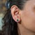A matched pair of Zambian emeralds glows in lush green in these solid 14K yellow gold bezel-set solitaire stud earrings....