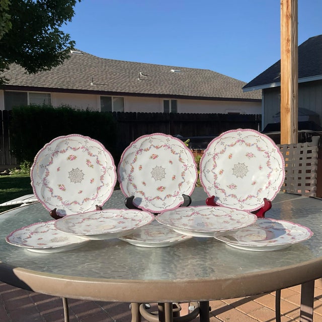 Set of 8 Scalloped Pink Luster Edged Plates by Merklesgrun Porcelain Factory of Bavaria circa 1912-1918. These plates are...