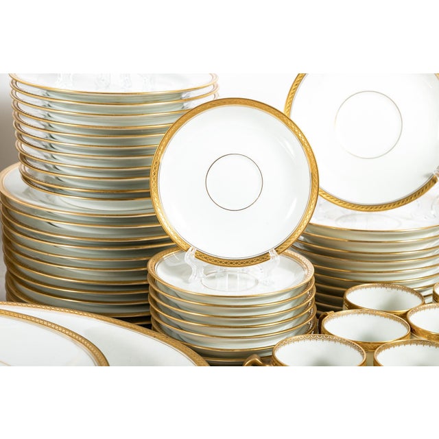 A large set of Haviland Limoges Marquis French porcelain dinnerware in bright white with richly gilt trim etched with an x...