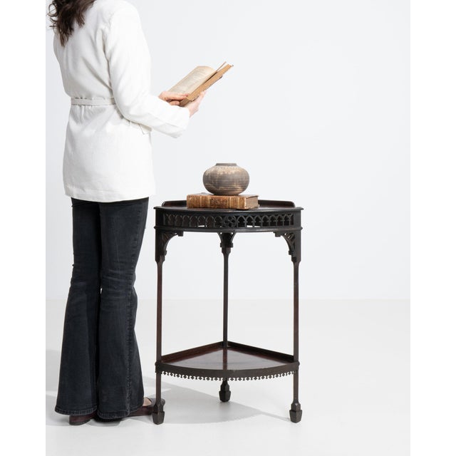 Ebonized tripod side table in Deep Ebony Black. The deep ebony black surface highlights triangular top, turned pedestal...