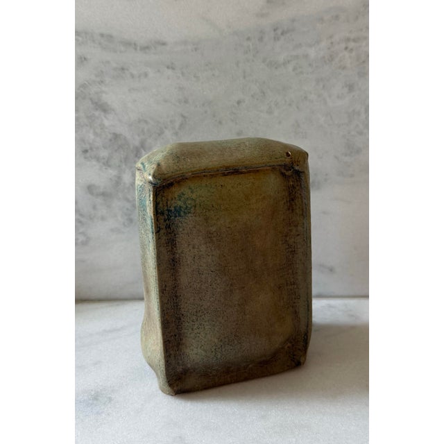 Vintage studio art pottery sculpture with wonderful organic shape and design and a beautiful brown green color. Signed by...