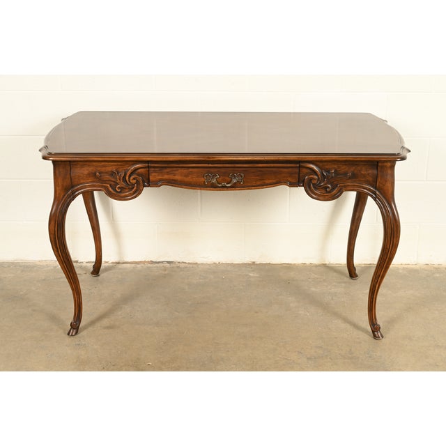A gorgeous French Provincial Louis XV style carved walnut writing desk By Tomlinson Furniture USA, Circa 1950s Carved...
